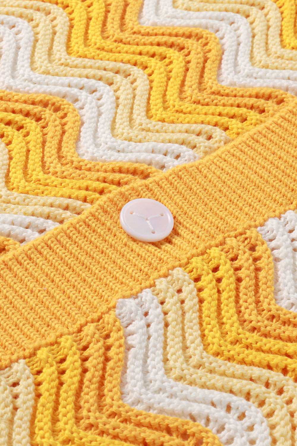 Close-up of yellow and white shale stitch knit shirt with button placket.