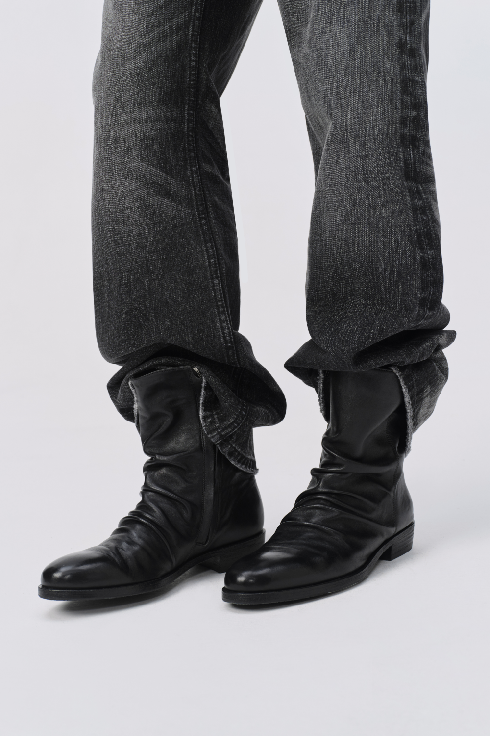 YITAI Horsehide Leather Boots in black, worn with washed black denim cuffed over the shaft.