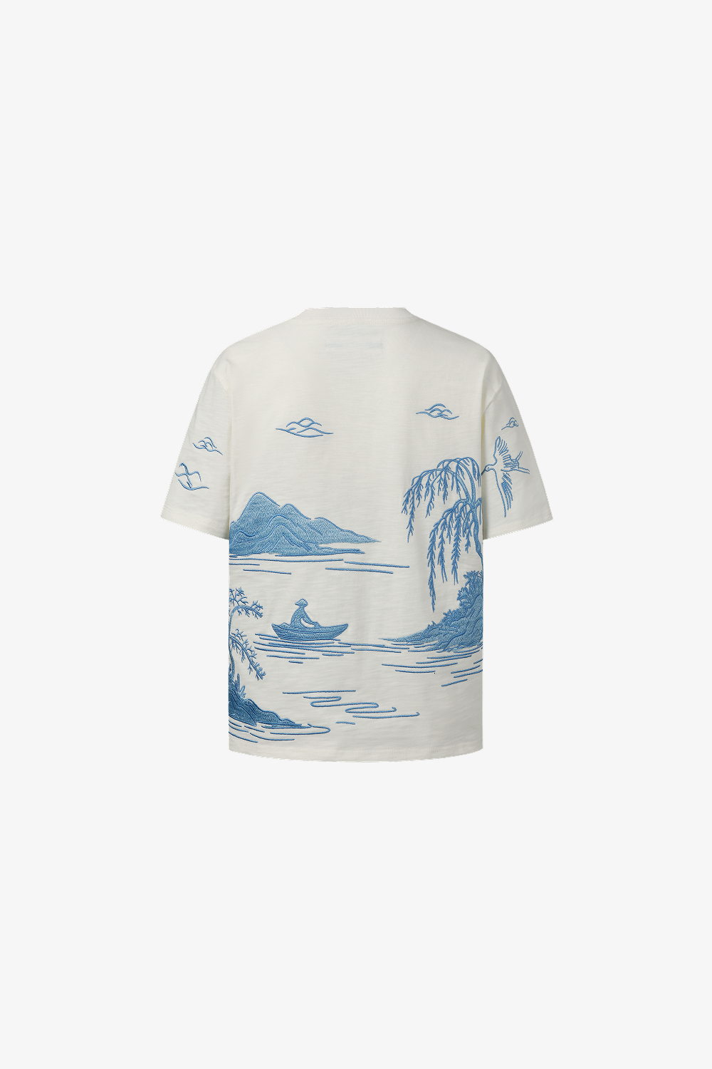 White t-shirt with blue nature-themed embroidery on a white background