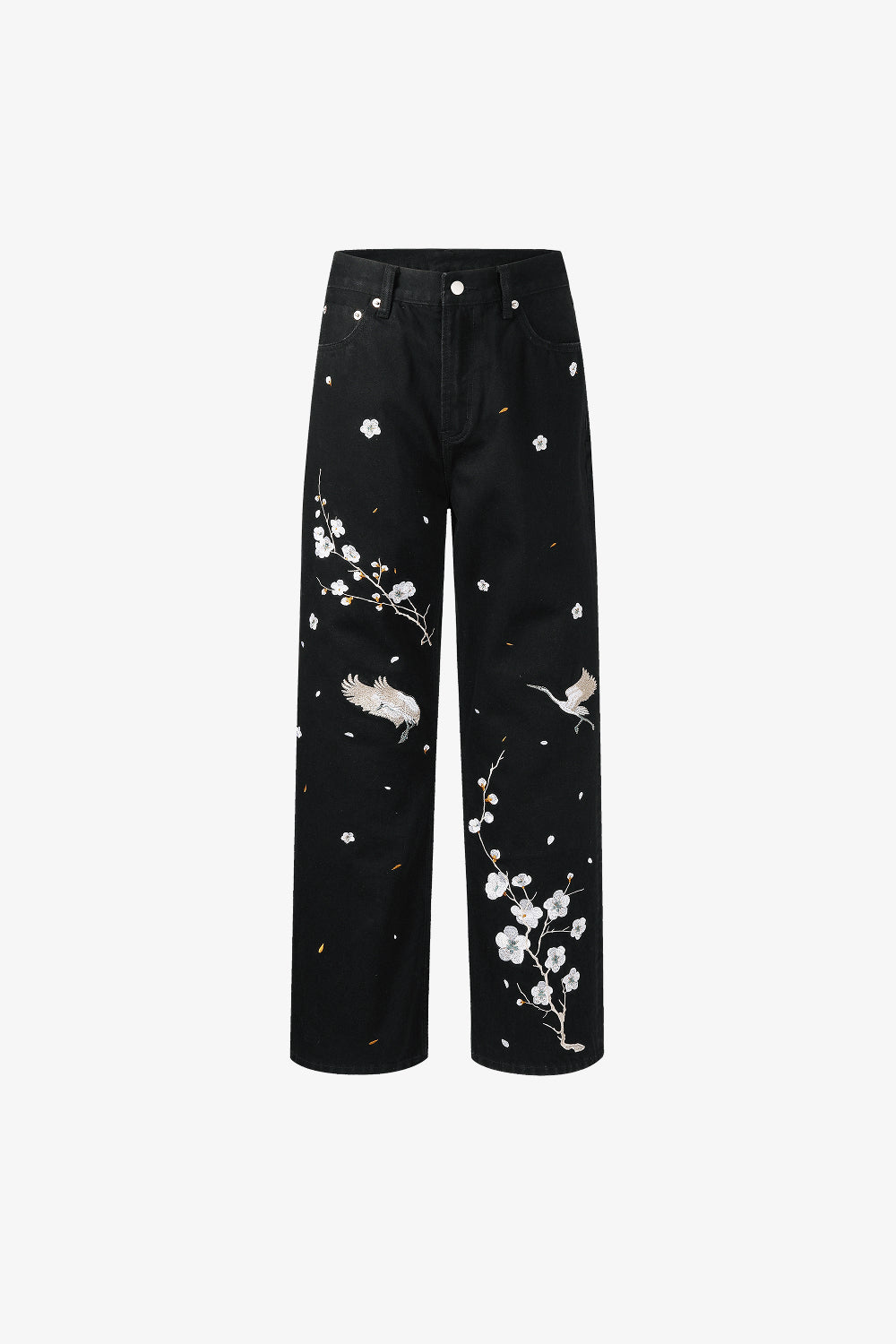 Black jeans with white floral and bird embroidery on a white background