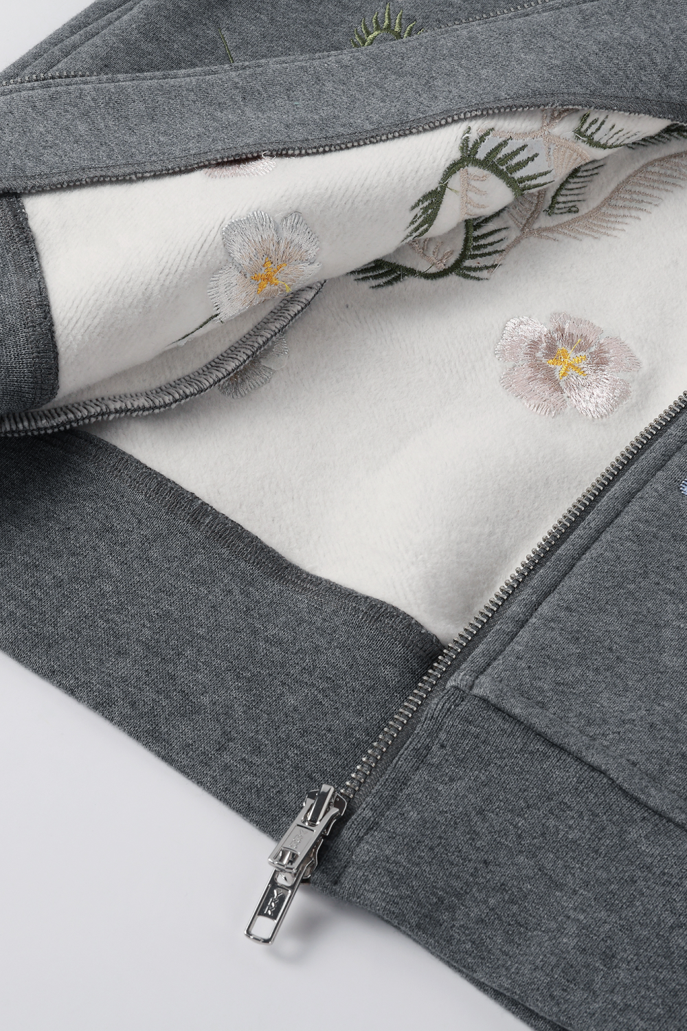 Close-up view of the white hoodie lining and the embroidery details from the inside.