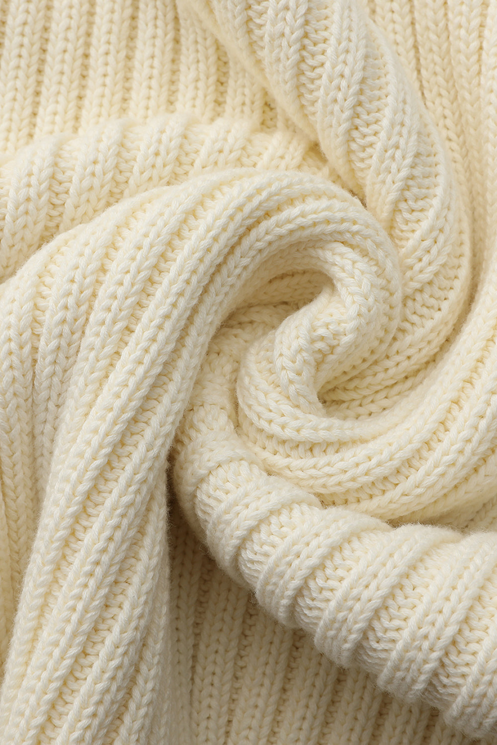 Close-up of a cream-colored knitted fabric