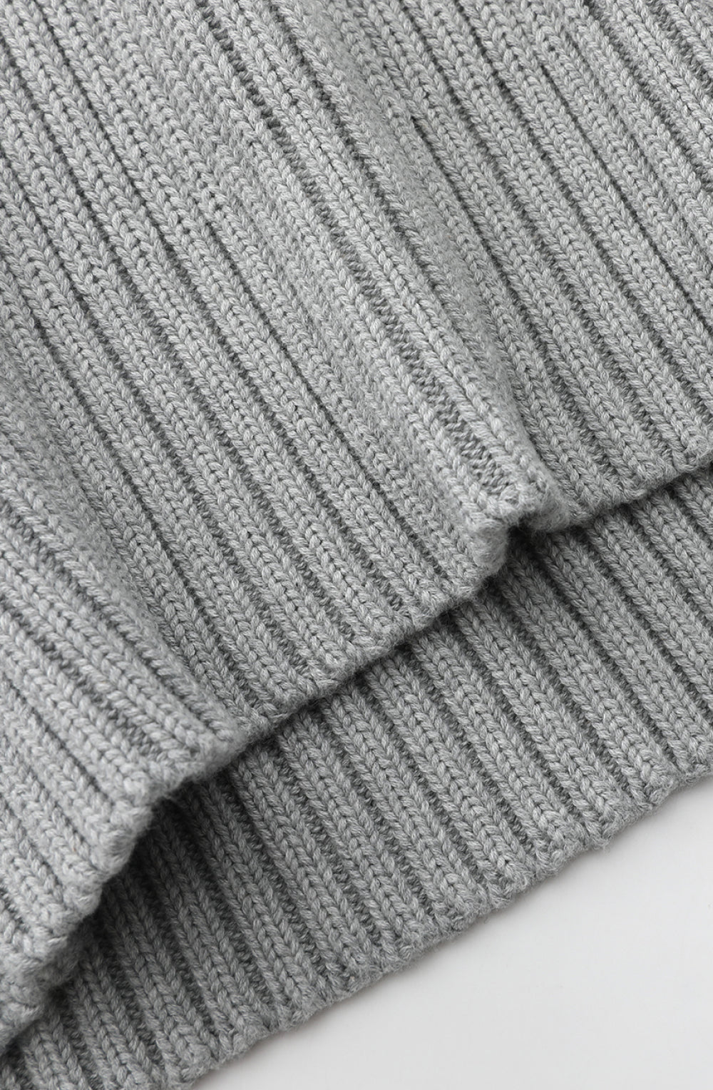 Close-up of gray ribbed fabric on a white background