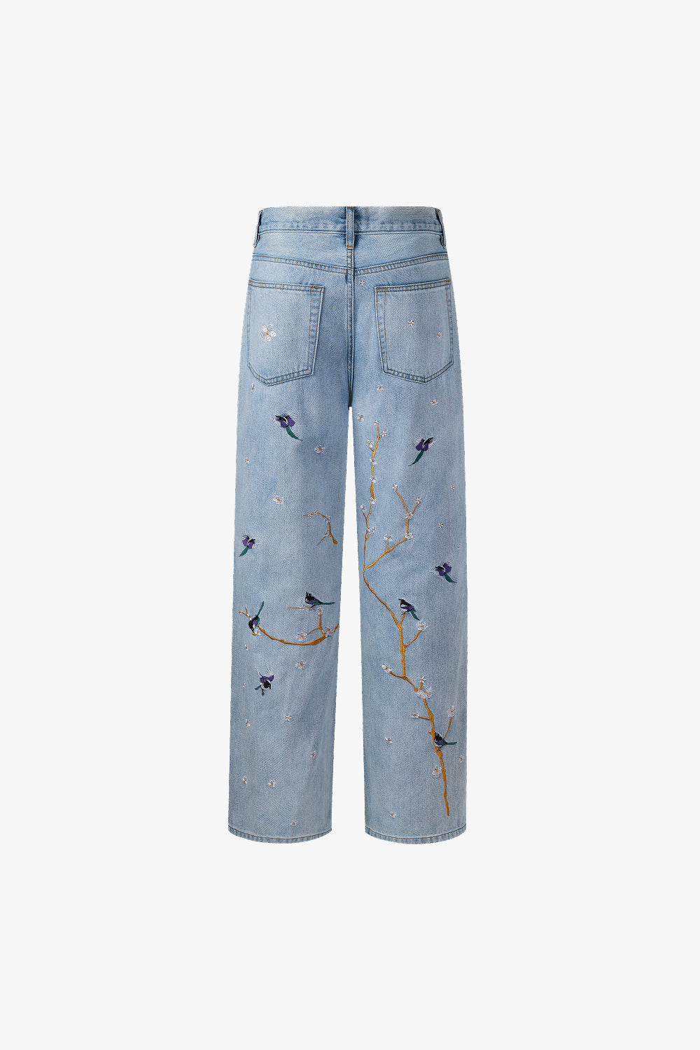 Back view of light blue denim jeans with bird and branch embroidery