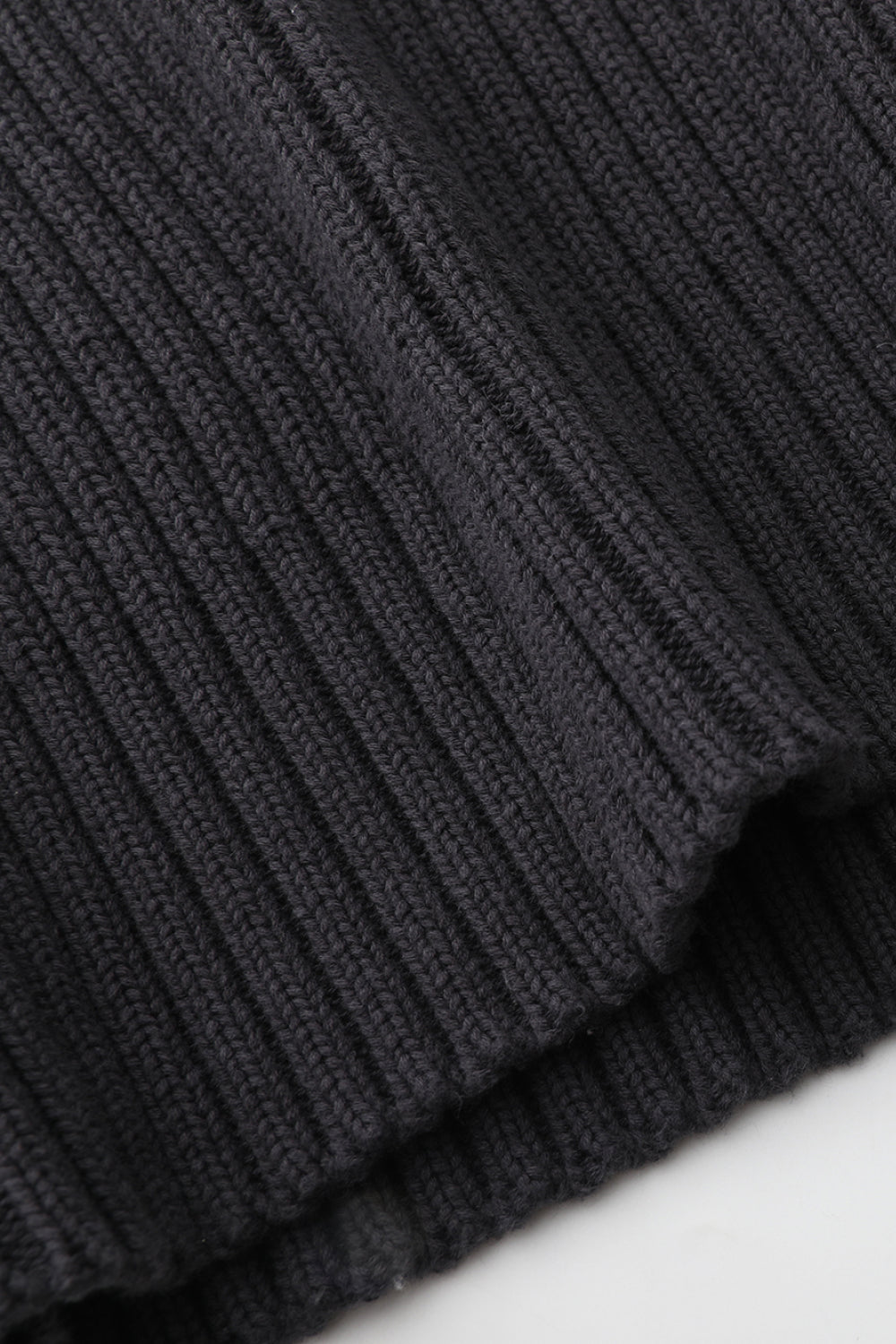 Close-up of a dark gray ribbed fabric texture
