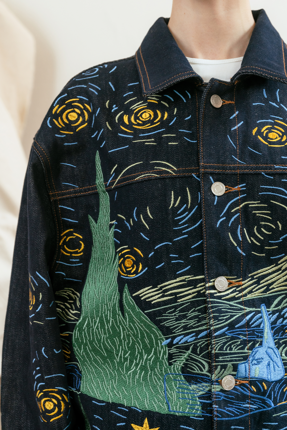 Denim jacket with embroidered design inspired by 'The Starry Night' by Van Gogh