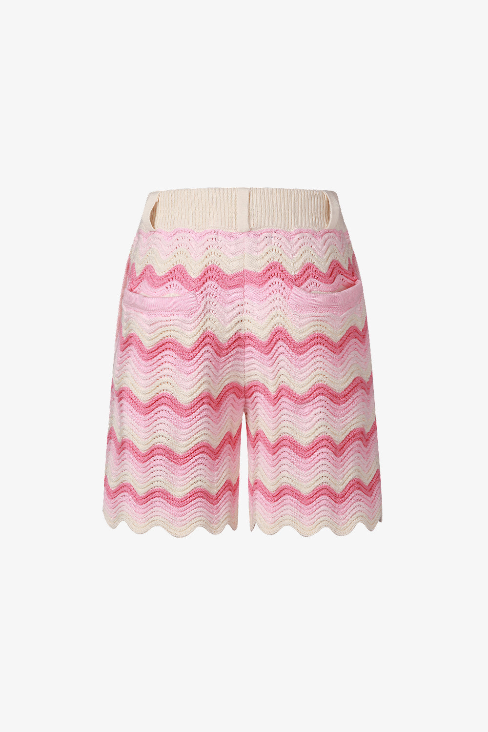 Back view of pink and cream shale stitch knit shorts with scalloped hem.