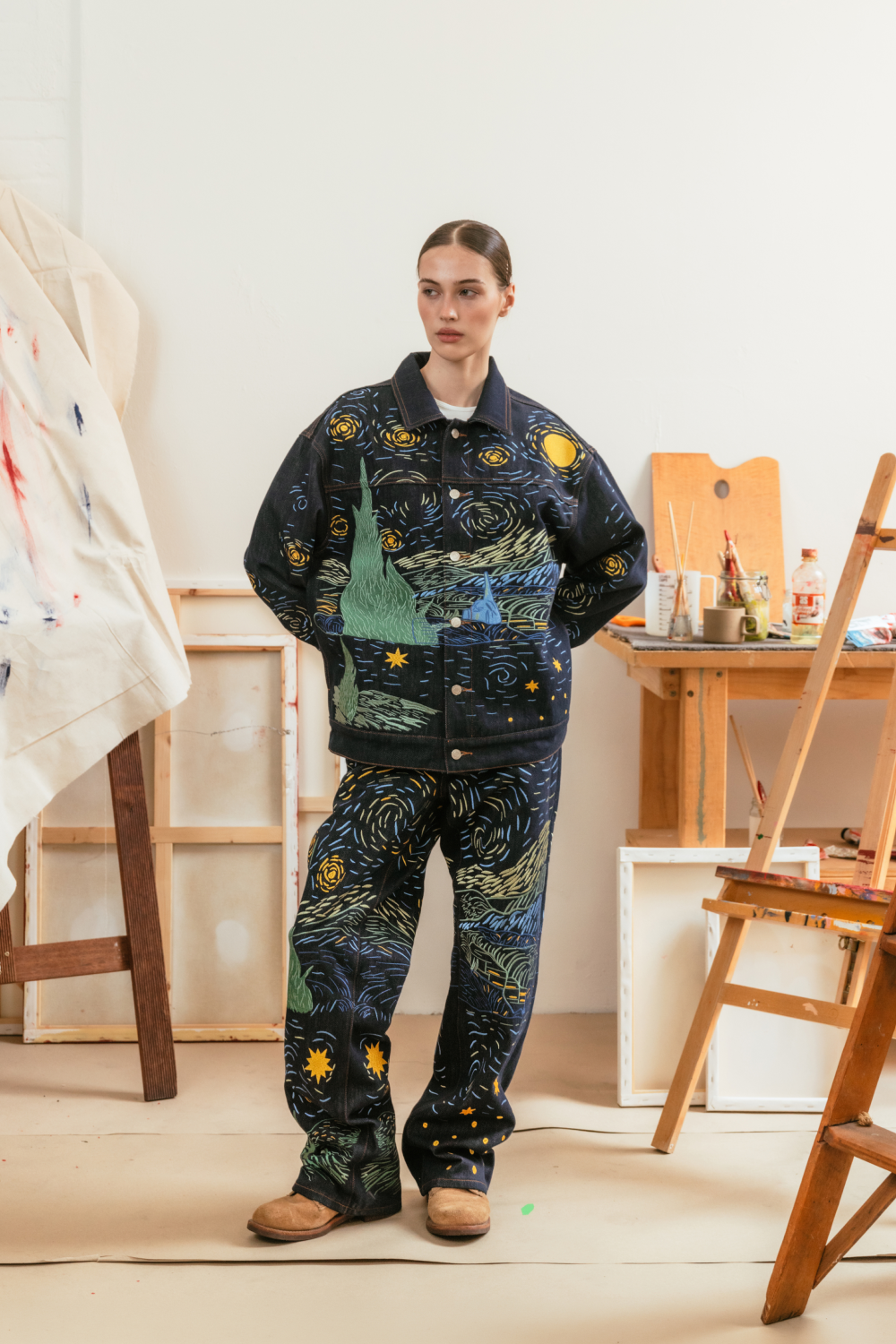 Model wearing a matching Starry Night-inspired denim jacket and jeans set.