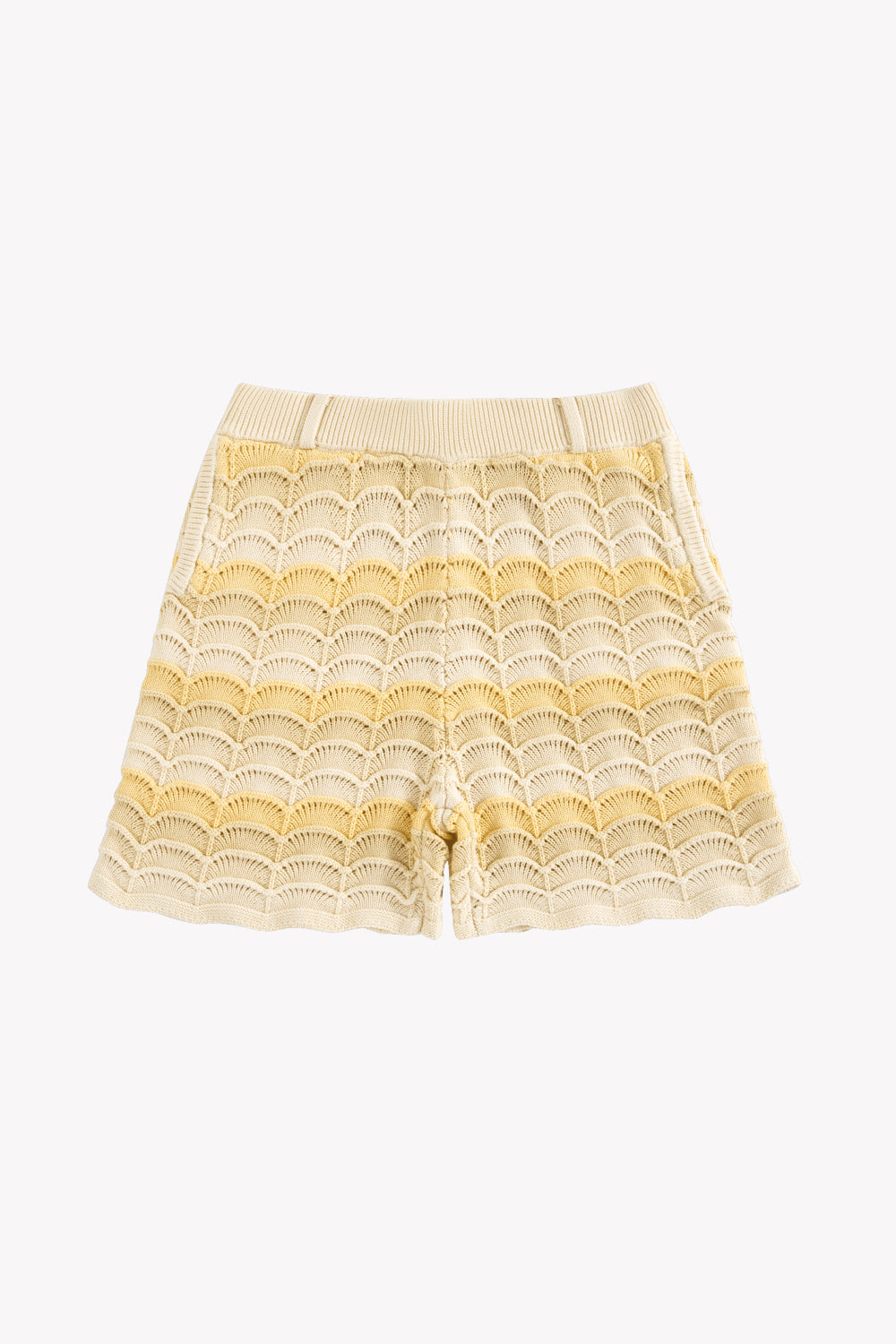 Cream and yellow knit shorts with scalloped wave pattern and ribbed waistband.