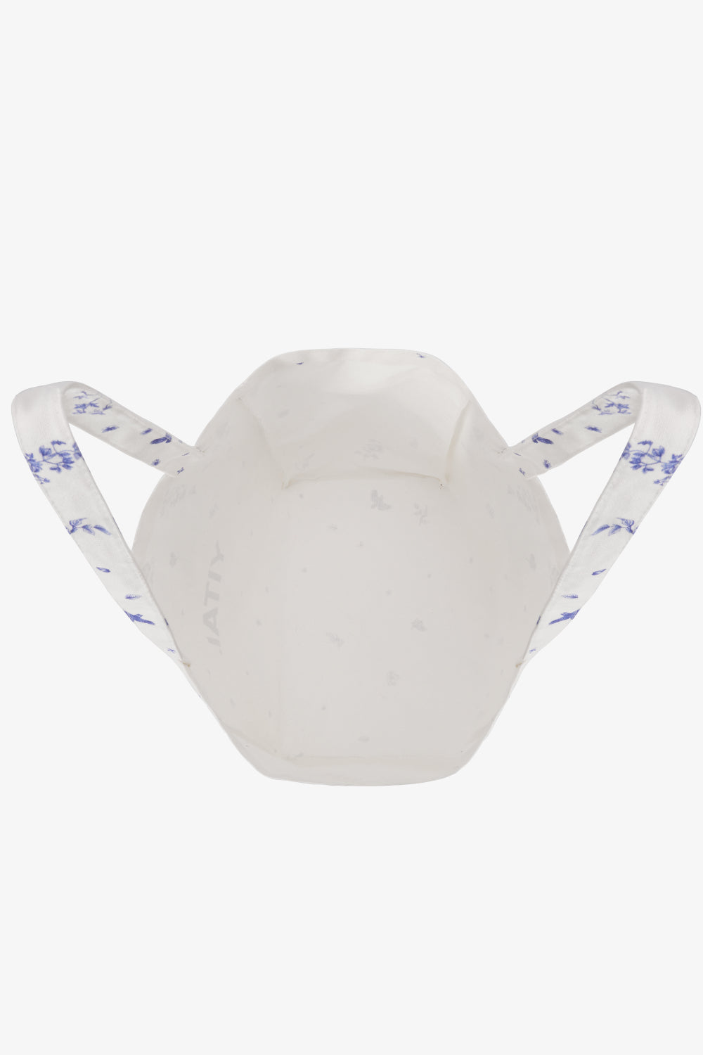 Interior of white tote bag and blue floral detailing on the handles