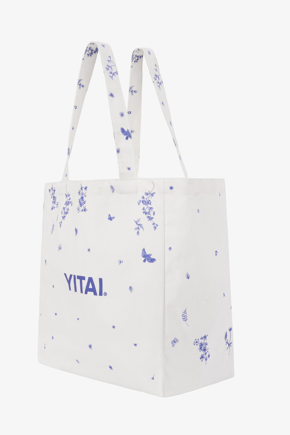 White tote bag with blue floral patterns and 'YITAI' branding on a white background