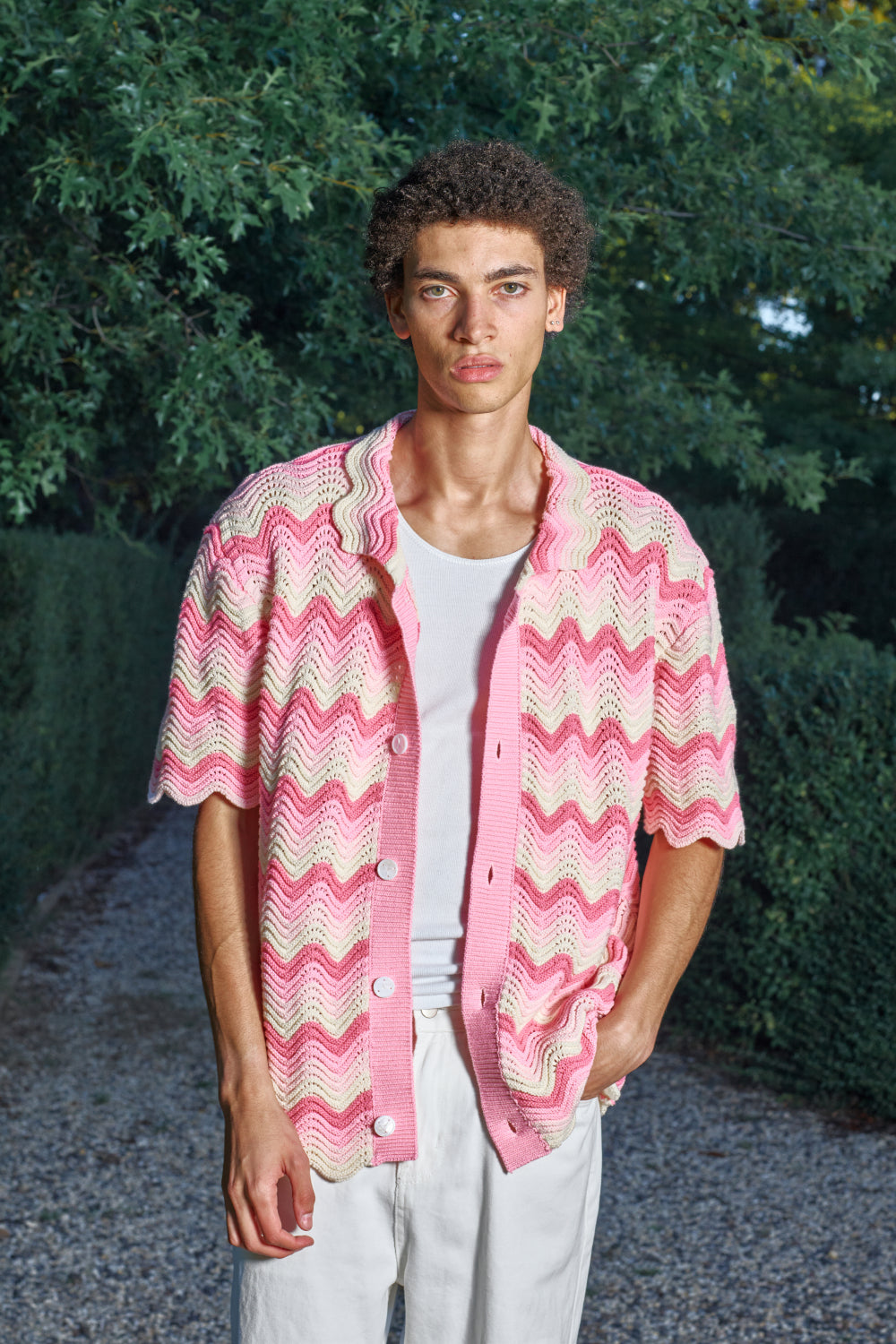 Model wearing a pink and cream shale stitch shirt outdoors