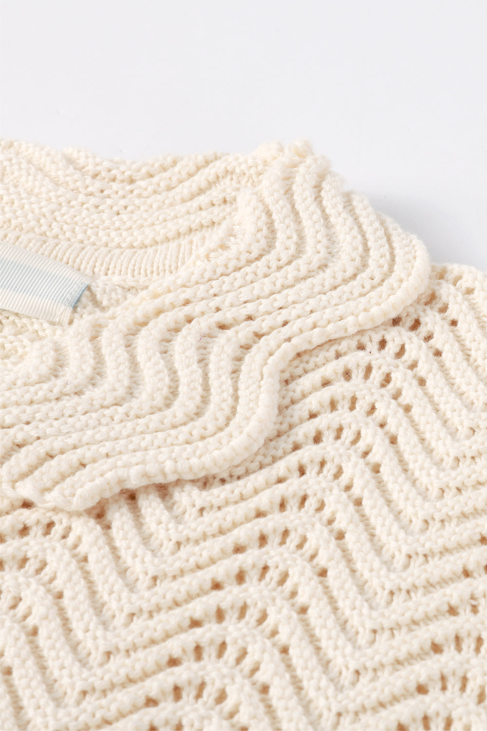 Close-up of ivory shale stitch shirt with scalloped collar.