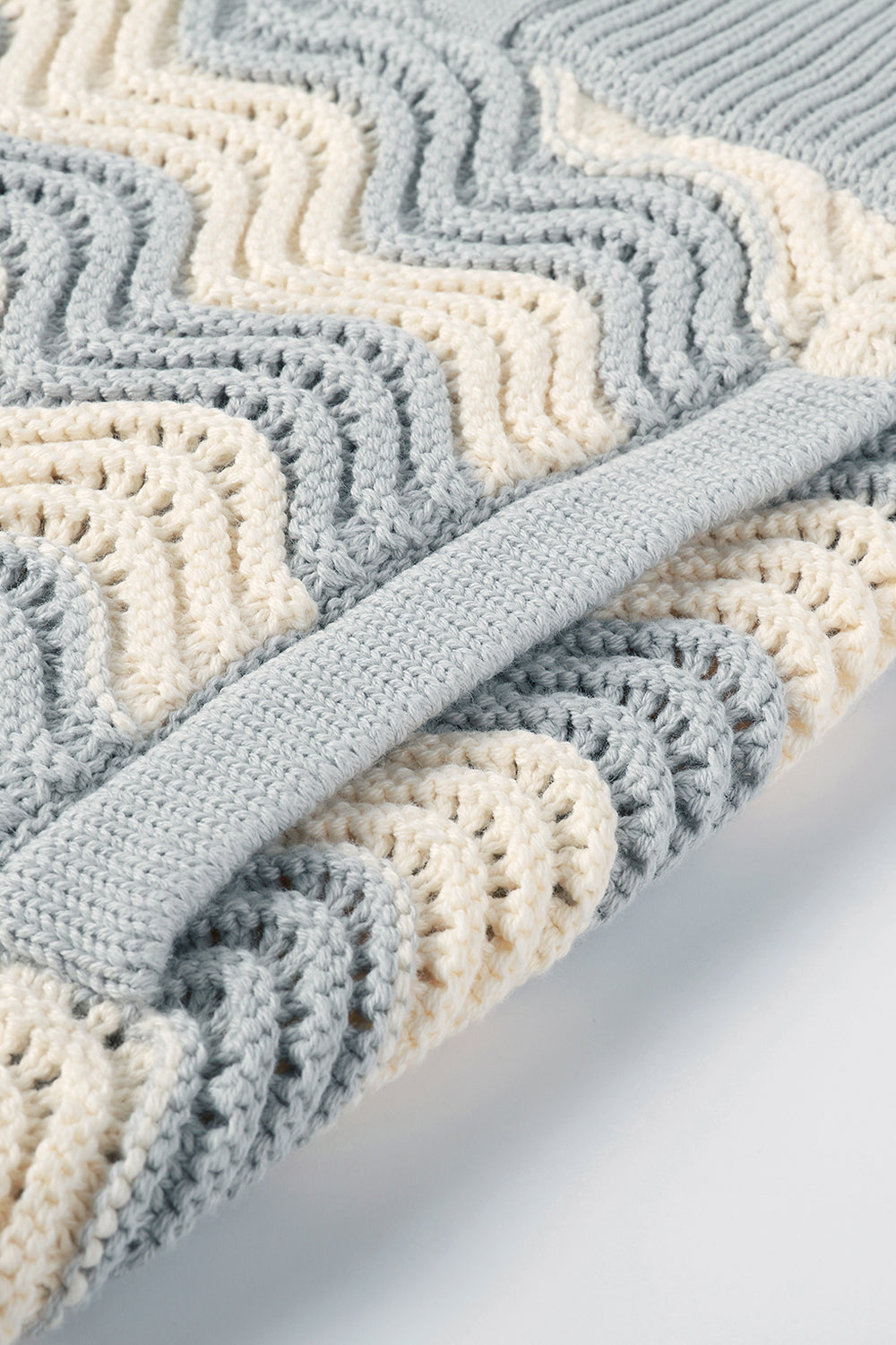 Close-up of grey and white shale stitch knit shorts with side pocket.