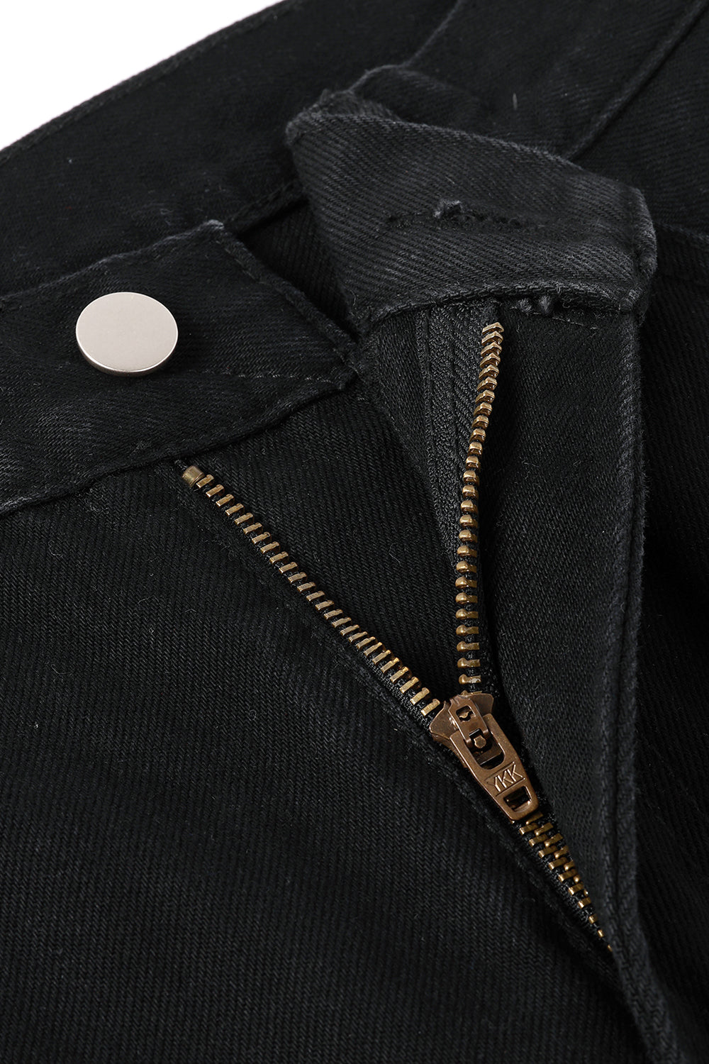 Close-up of black jeans with metal zipper and button closure detail
