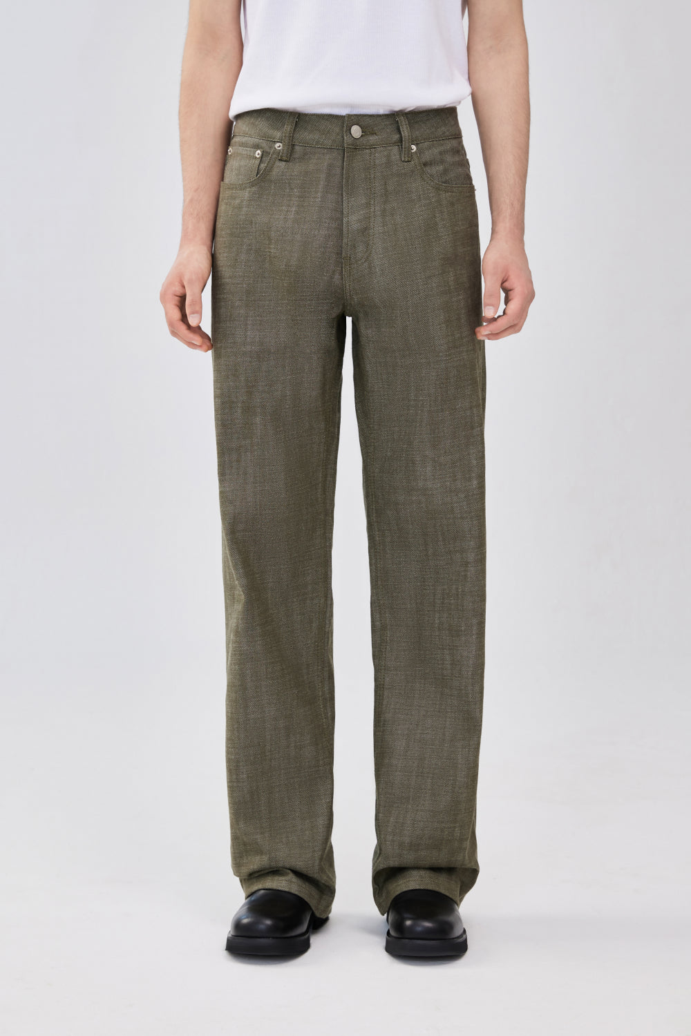 Model wearing military green selvedge straight-leg denim jeans.