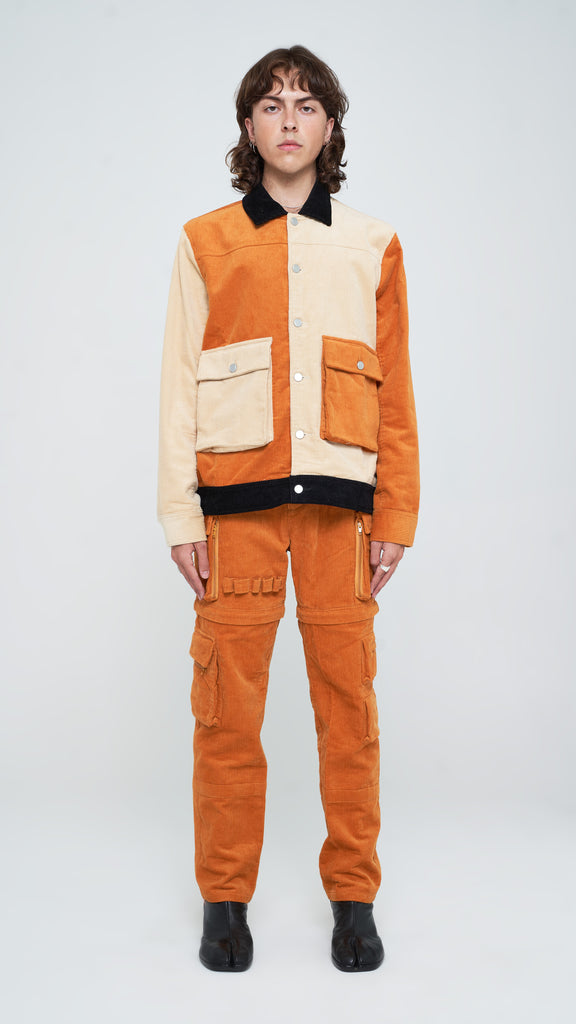 The three-toned corduroy jacket is the perfect piece to add a touch of classic yet subtle style to your rotation. Constructed from pure cotton corduroy and dressed in Apricot Brown, Oatmeal, and Jet Black, this piece is detailed with a classic collar and custom "Y.T.G." button closure. Finished with extended duo cargo pockets with slit inserts on each side, this piece is a must-have in your wardrobe for every season.