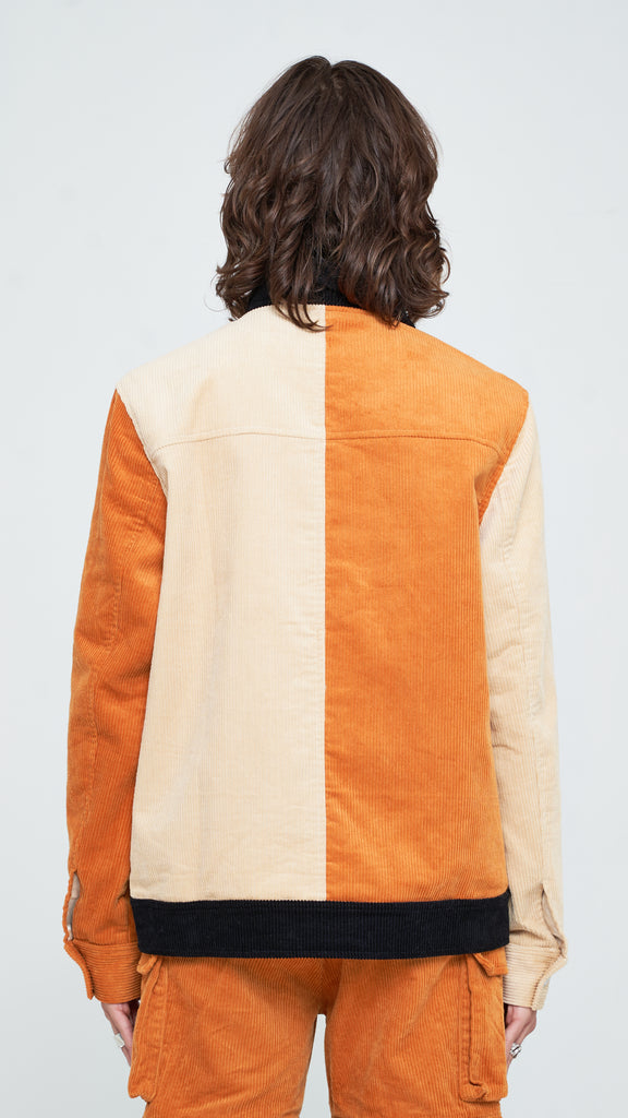 The three-toned corduroy jacket is the perfect piece to add a touch of classic yet subtle style to your rotation. Constructed from pure cotton corduroy and dressed in Apricot Brown, Oatmeal, and Jet Black, this piece is detailed with a classic collar and custom "Y.T.G." button closure. Finished with extended duo cargo pockets with slit inserts on each side, this piece is a must-have in your wardrobe for every season.